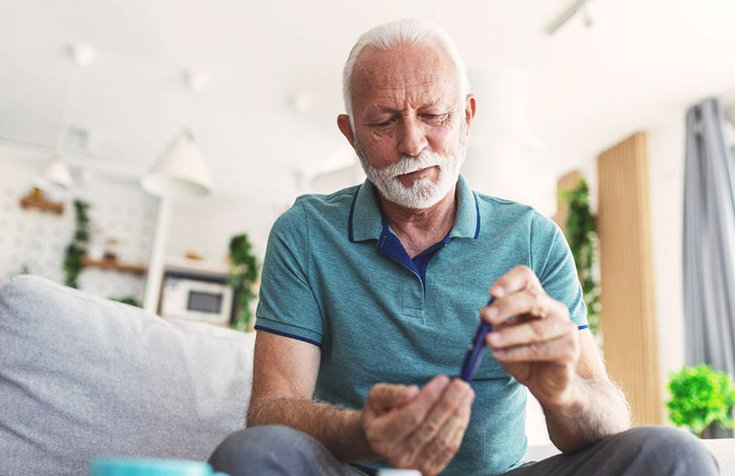 A diabetic patient using a glucose monitoring device at home